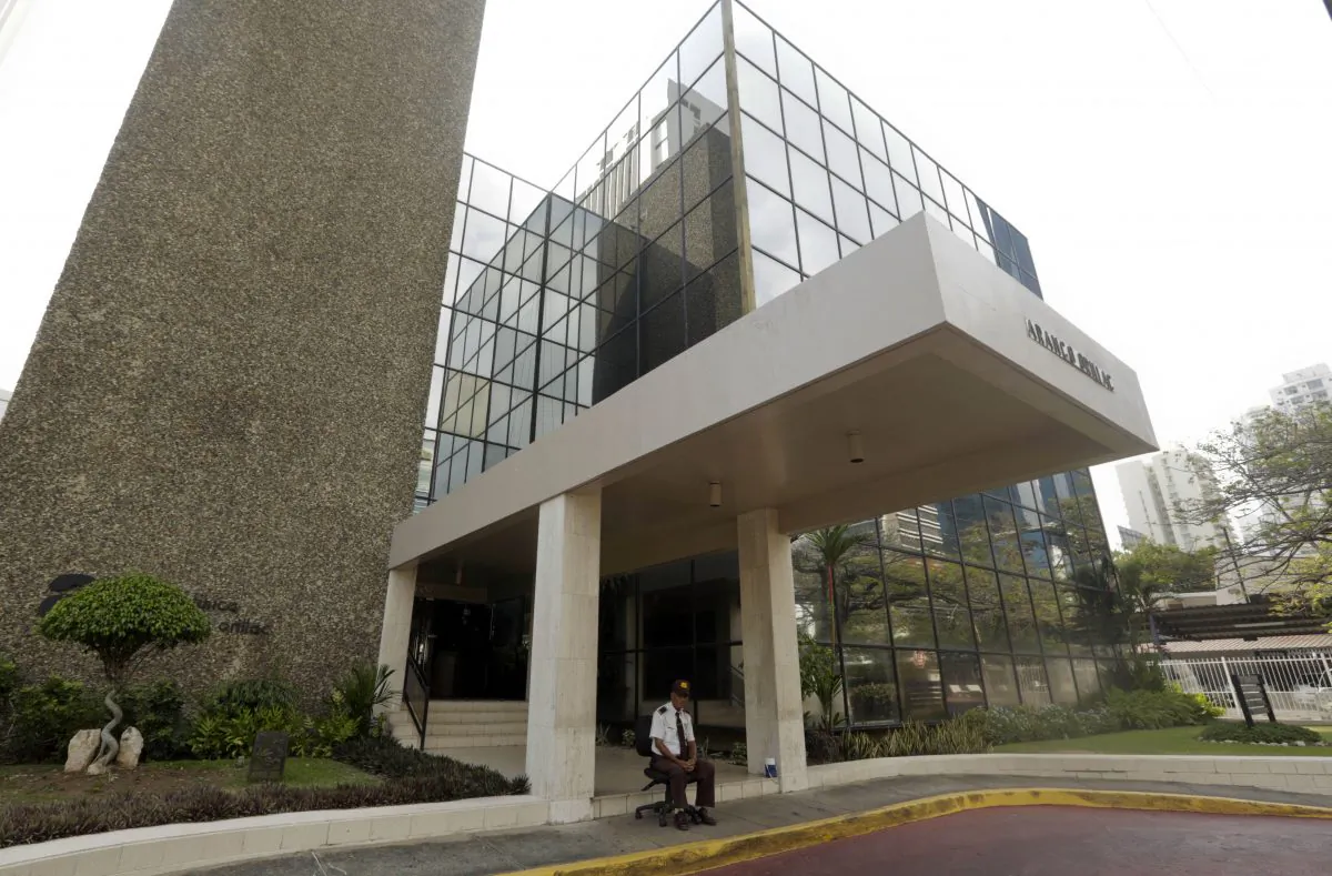 A security guard sit outside the Mossack Fonseca law firm in Panama City, April 3, 2016. Approximately 11 million documents with information on offshore bank account holders were leaked from the office of the law firm in 2016.(AP Photo/Arnulfo Franco)