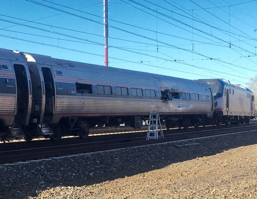 An Amtrak train crashes on April 3, 2016, in Chester, Pa. Amtrak said the train was heading from New York to Savannah, Ga., when it struck a backhoe outside of Philadelphia. (Glenn R. Hills Jr via AP)  