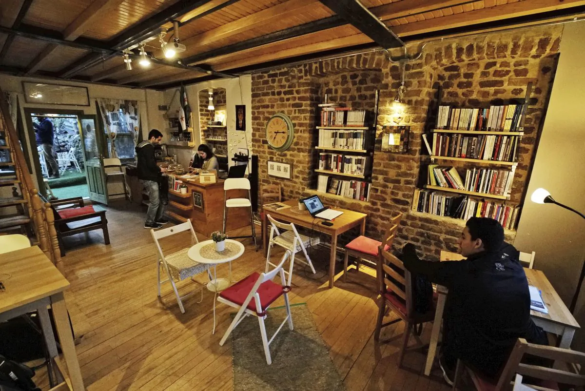 Customers are seen Pages, a rustic three story-Arabic language bookshop in Istanbul, Turkey, on  April 1, 2016. The bookstore has become an anchor for many Syrians who have stayed put in Turkey but crave a taste of home. The founder and owner of Pages, Samer al-Kadri, a refugee himself, says the store strives to be a bridge between Syrians, Turks and the myriad of foreigners who visit the city. Its weekly program includes oriental music concerts and, starting soon, language exchanges in Arabic, English and Turkish. Books are available in all three languages. (AP Photo/Bram Janssen)