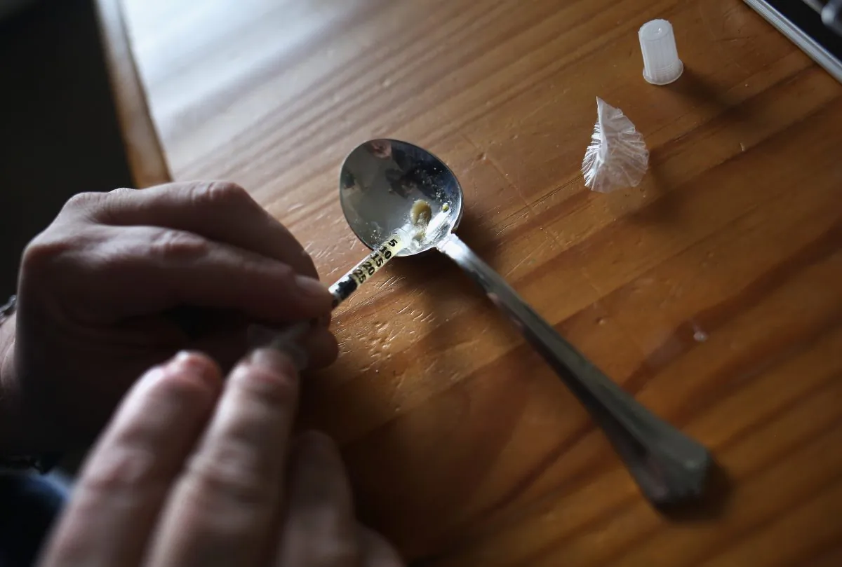 A heroin user prepares to inject himself in New London, Conn., on March 23, 2016. (John Moore/Getty Images)