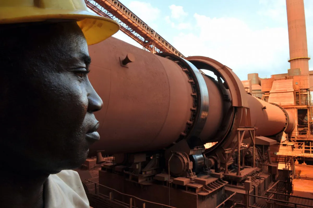 A technician checks operations at Guinea's largest bauxite mining firm, Compagnie des Bauxites de Guinee (CBG), at Kamsar, a town north of the capital Conakry, on Oct. 23, 2008. (Georges Gobet/AFP/Getty Images)