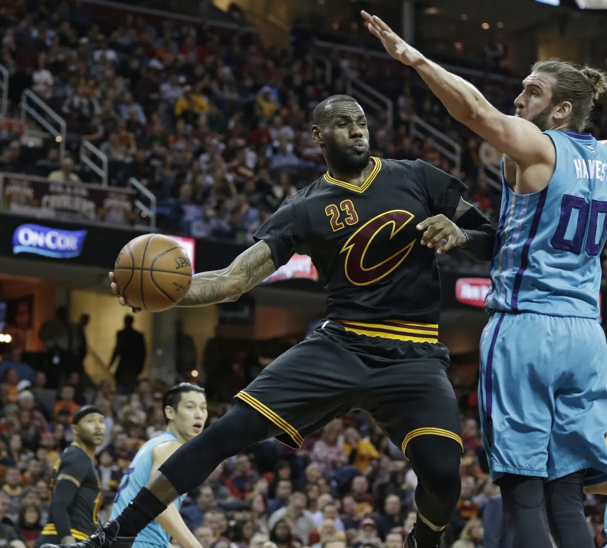 LeBron James (C) scored 31 points and dished out 12 assists in Cleveland's April 3 win over Charlotte. (AP Photo/Tony Dejak)