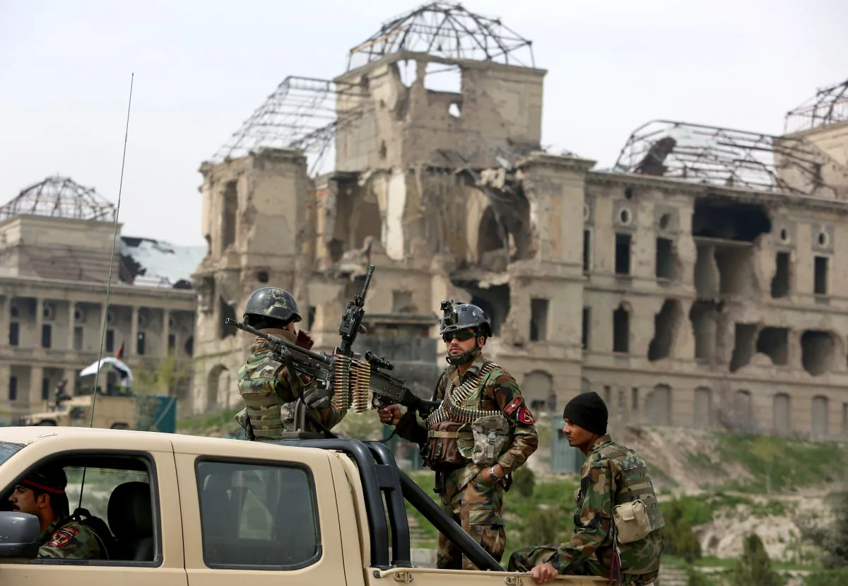 Afghan military soldiers stand stand alert at the entrance gate of the new parliament building after a rocket attack in Kabul, Afghanistan, Monday, March 28, 2016. (AP Photo/Rahmat Gul)