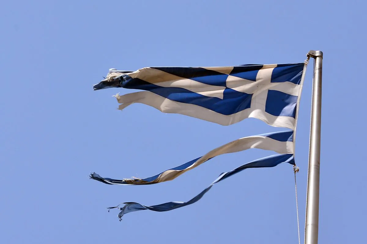 A ripped off Greek national flag flutters in central Athens on July 22, 2015. (Louisa Gouliamaki/AFP/Getty Images)