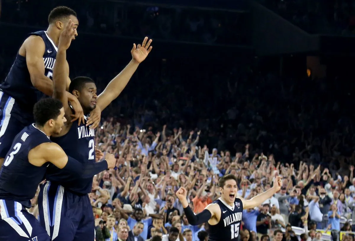 Kris Jenkins of the Villanova Wildcats celebrates wth teammates after making the game-winning three-pointer to defeat the North Carolina Tar Heels 77–74 for the national championship. (Streeter Lecka/Getty Images)