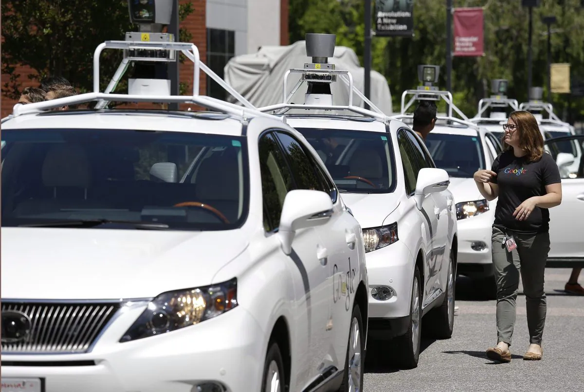 A row of Google self-driving Lexus cars are parked at a Google event in Mountain View, Calif., on May 13, 2014. (AP Photo/Eric Risberg)