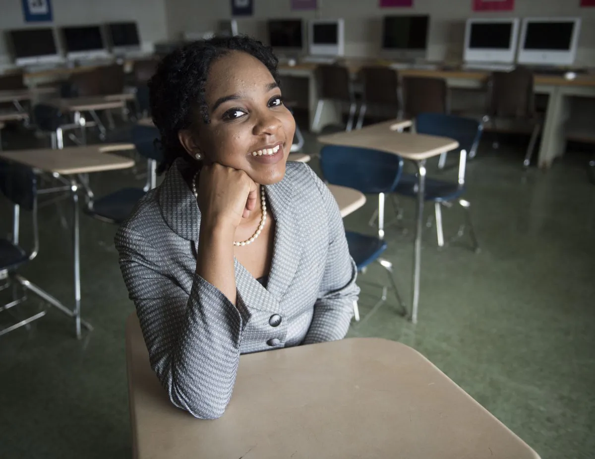 Elmont Memorial High School valedictorian Augusta Uwamanzu-Nna poses for a photo in an empty classroom on Monday, April 4, 2016 in Elmont, N.Y. (Alejandra Villa/Newsday via AP)