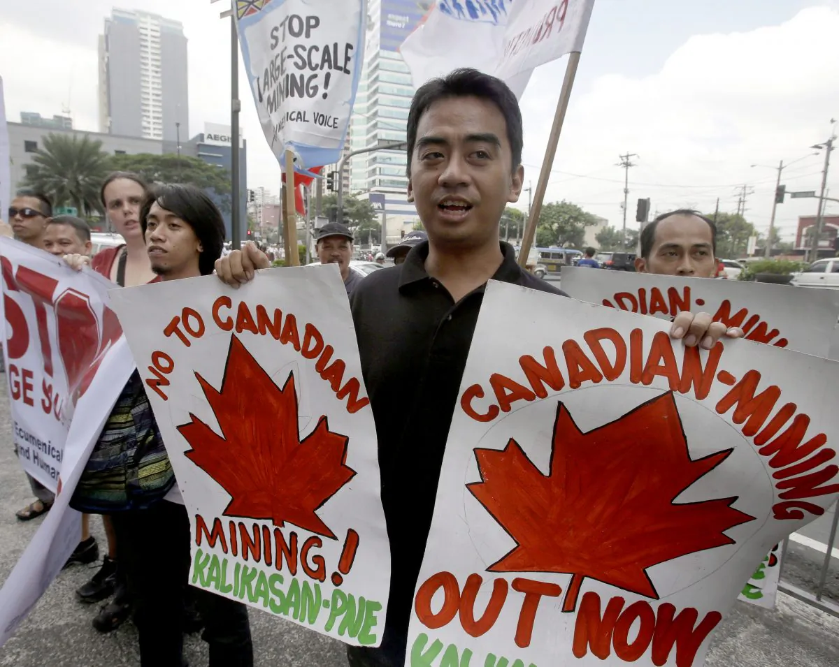Protesters demonstrate outside the Canadian Embassy in Manila to coincide with an official visit by former prime minister Stephen Harper on Nov. 9, 2012. The protesters were demanding a stop to alleged long-standing environmental crimes by Canadian mining companies in the Philippines. (AP Photo/Bullit Marquez)