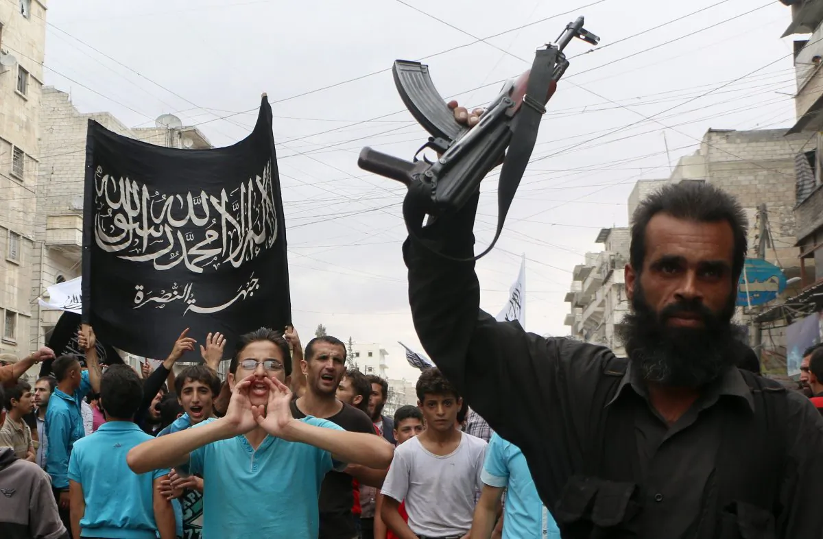 Supporters of the Nusra Front, an al-Qaeda affiliate, take part in a protest against Syrian President Bashar al-Assad and the international coalition in Aleppo on Sept. 26, 2014. Al-Qaeda and ISIS are competing for influence over the global jihadist movement. (Fadi al-Halabi/AFP/Getty Images)