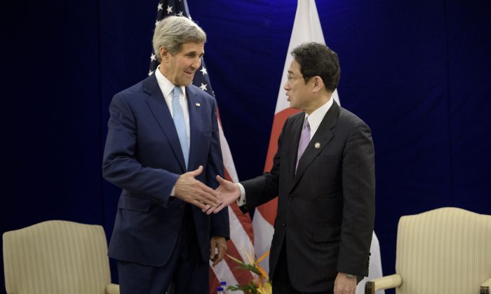 US Secretary of State John Kerry (L) and Japans Foreign Minister Fumio Kishida shake hands before a bilateral meeting in Kuala Lumpur on August 6, 2015.    AFP PHOTO / POOL / BRENDAN SMIALOWSKI        (Photo credit should read BRENDAN SMIALOWSKI/AFP/Getty Images)