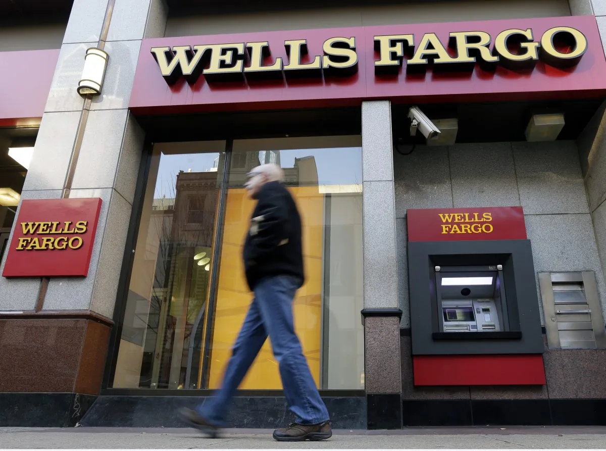 In this Wednesday, Dec. 19, 2012, file photo, a man walks past a Wells Fargo location in Philadelphia. (AP Photo/Matt Rourke)