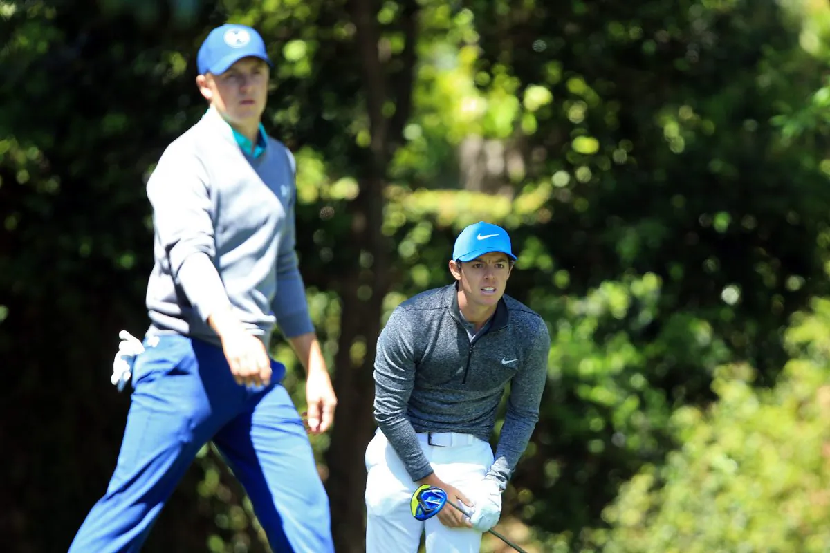 Rory McIlroy (R) reacts to his shot from the second tee as Jordan Spieth of the United States walks from the tee during the third round of the 2016 Masters Tournament at Augusta National Golf Club in Augusta, Georgia. (David Cannon/Getty Images)