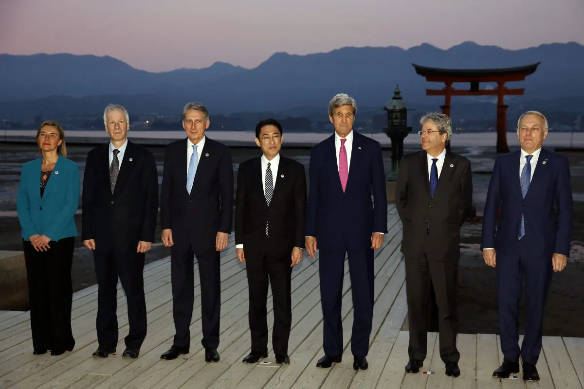 Japanese Foreign Minister Fumio Kishida (C) stands with other G7 foreign ministers, (L-R) EU High Representative for Foreign Affairs Federica Mogherini, Canadian Foreign Minister Stephane Dion, British Foreign Secretary Philip Hammond, Kishida, U.S. State Secretary John Kerry, Italian Foreign Minister Paolo Gentiloni, and French Foreign Minister Jean-Marc Ayrault at the Itsukushima Shrine, as they take a cultural break from their G7 foreign ministers meetings in nearby Hiroshima to visit Miyajima Island, Japan, on April 10, 2016. (Jonathan Ernst/AP)