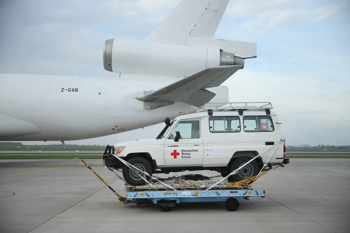 A 4X4 jeep of the German Red Cross (DRK), part of a 25-ton shipment of tents, generators, air-conditioning units, chlorine for disinfection and other supplies destined for Ebola treatment centers in Sierra Leone, stands on the tarmac shortly before ground crews loaded it onto a plane at Schoenefeld Airport on November 4, 2014 in Schoenefeld, Germany. (Sean Gallup/Getty Images)