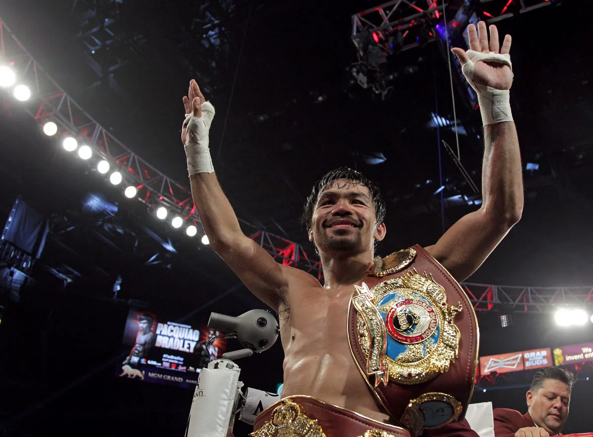 Manny Pacquiao gestures to fans celebrating after defeating Timothy Bradley Jr. in a 12-round unanimous decision at the MGM Grand Arena on April 9 in Las Vegas, Nevada. (John Gurzinski/AFP/Getty Images)