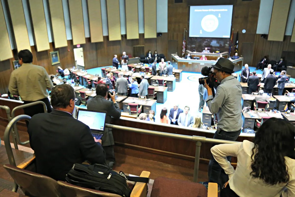 Arizona Republic photographer Nick Oza and Associated Press journalist Bob Christie report from the gallery of the Arizona House of Representatives in Phoenix, Ariz., on April 7, 2016. (AP Photo/Ryan VanVelzer)