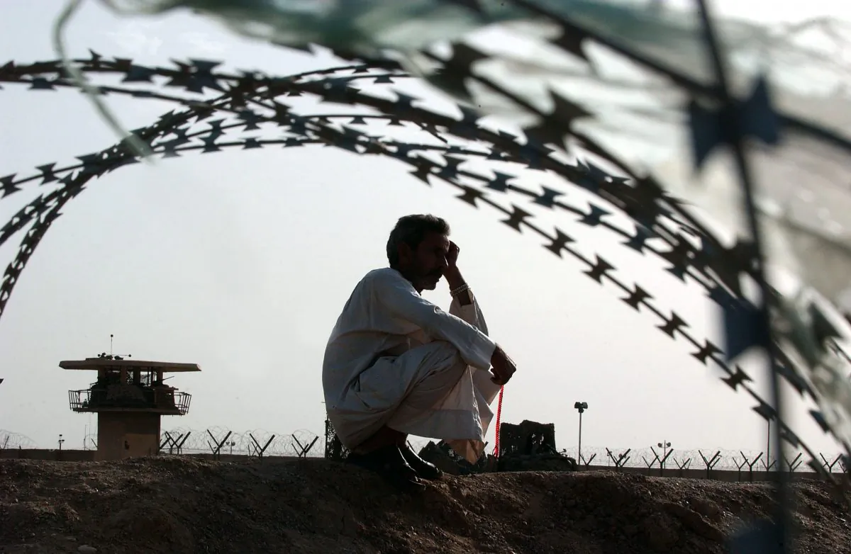 An Iraqi man waits for the release of his relative detained in the Abu Ghraib prison, outside of Baghdad, Iraq, on May 21, 2004. (Wathiq Khuzaie/Getty Images)
