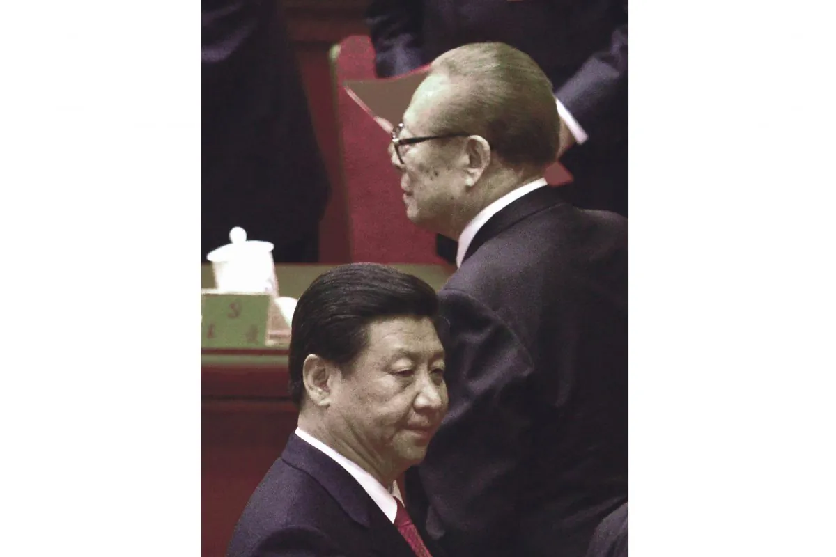Chinese former president Jiang Zemin(R) walks by Xi Jinping(L) after the closing of the 18th Communist Party Congress at the Great Hall of the People in Beijing on Nov 14, 2012. (Wang Zhao/AFP/Getty Images)