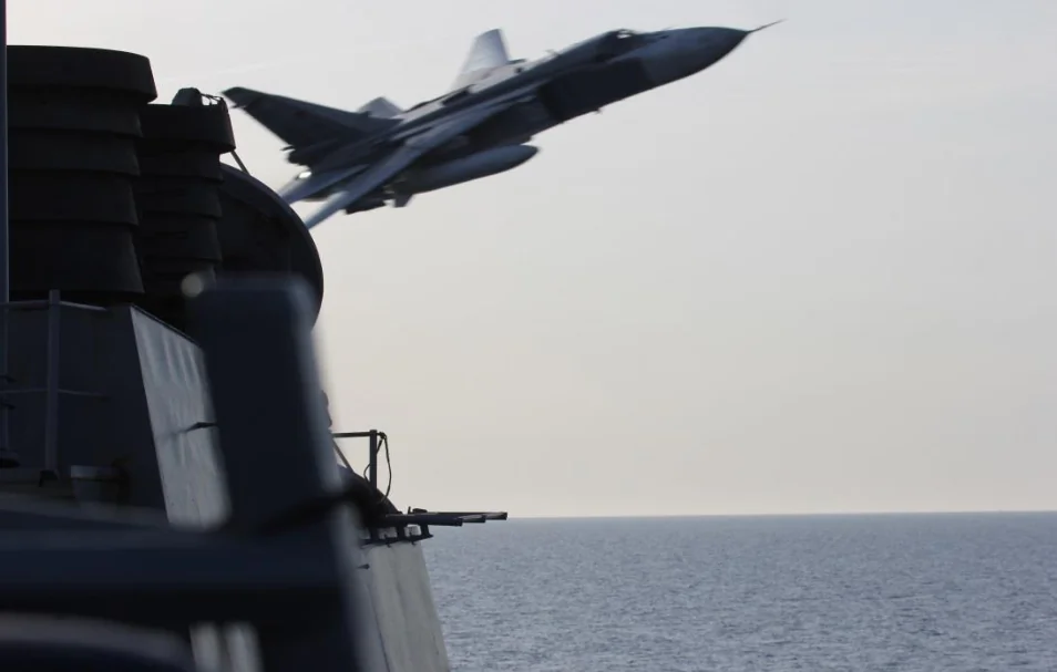 A Russian Sukhoi Su-24 attack aircraft makes a very-low altitude pass by the USS Donald Cook (DDG 75) April 12, 2016. Donald Cook, an Arleigh Burke-class guided-missile destroyer, forward deployed to Rota, Spain is conducting a routine patrol in the U.S. 6th Fleet area of operations in support of U.S. national security interests in Europe. (U.S. Navy 6th Fleet photo/Released)