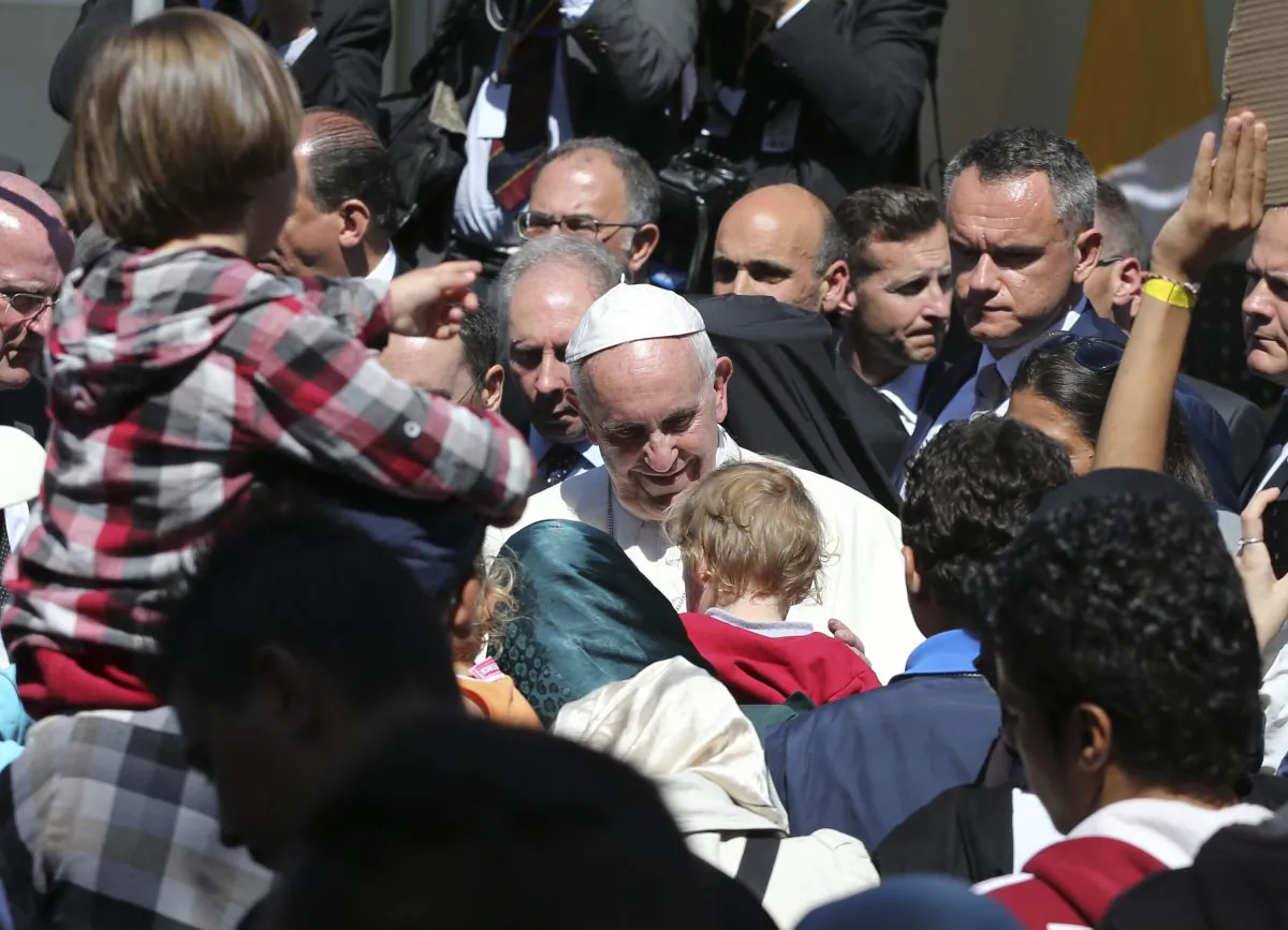 Pope Francis meets migrants at the Moria refugee camp on the Greek island of Lesbos, Saturday April 16, 2016. Pope Francis travelled Saturday to Greece for a brief but provocative visit to meet with refugees at a detention center as the European Union implements a controversial plan to deport them back to Turkey. (AP Photo/Petros Giannakouris)