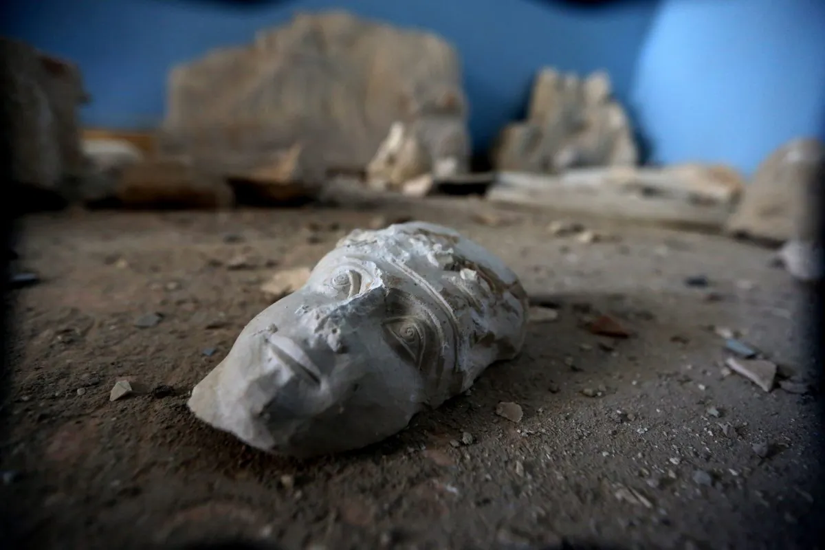 The face of a statue lies on the ground at the destroyed museum in the ancient Syrian city of Palmyra on March 31, 2016.  (Joseph Eid/AFP/Getty Images)