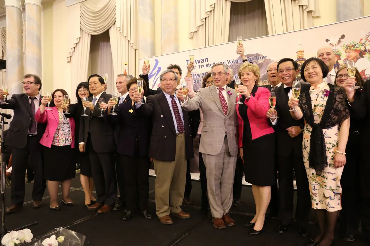 Attendees at Taiwan Night 2016 pose with a glass of champagne at Fairmont Chateau Laurier on April 13, 2016. (Donna He/Epoch Times)