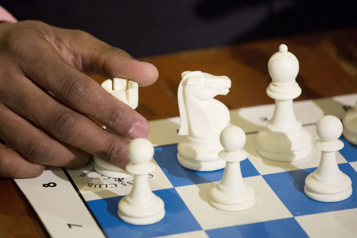 A chess player his hand on a rook piece in a 2016 file photo. (Mark Lennihan/AP Photo)
