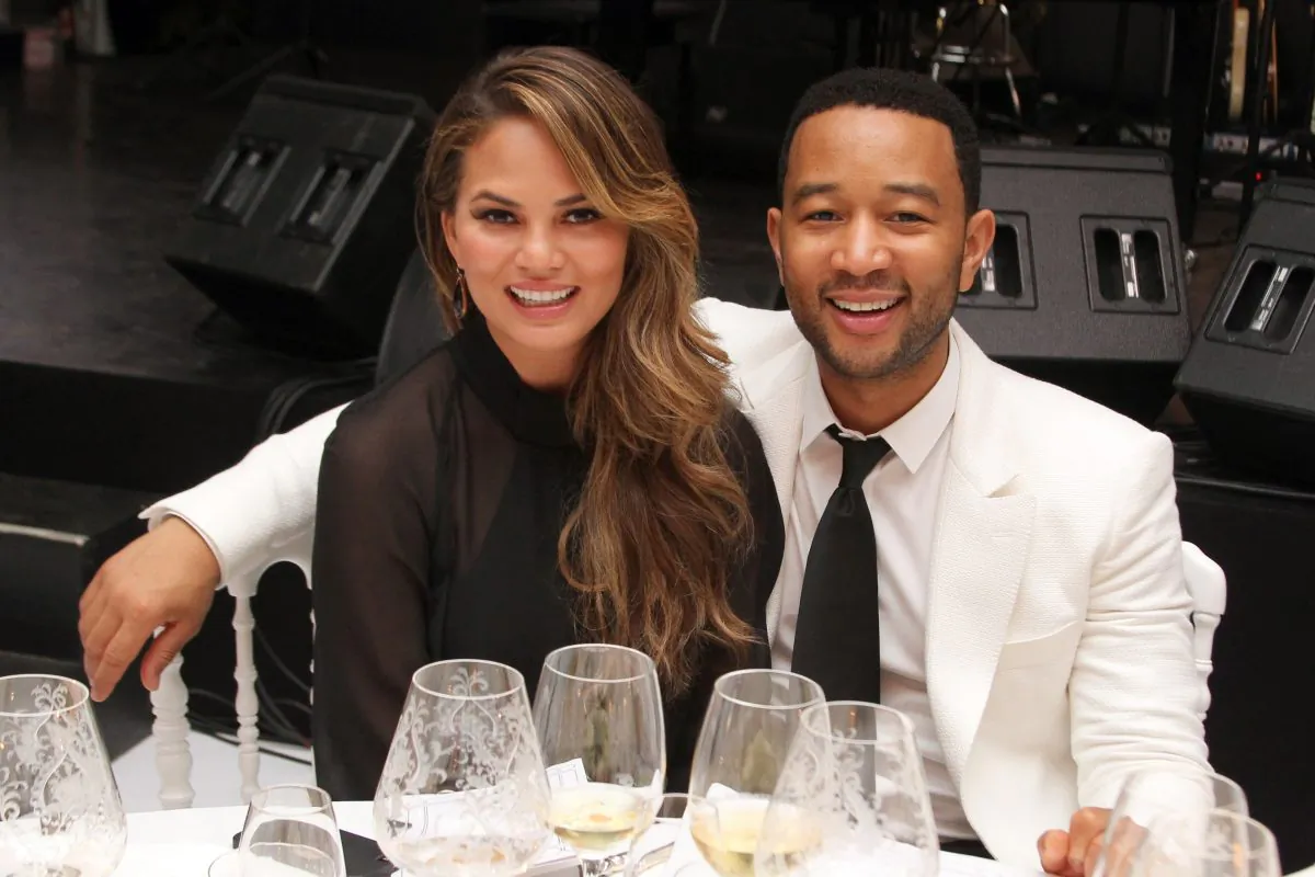 Chrissy Teigen and John Legend attend the White Party Dinner Hosted by Andrea and Veronica Bocelli Celebrating Celebrity Fight Night In Italy (Andrew Goodman/Getty Images for Celebrity Fight Night)