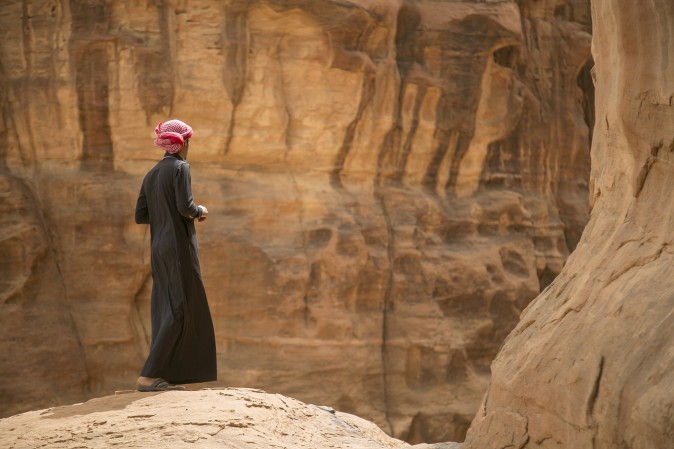 A Saudi man stands on the edge of a hill during a trip to the desert of Tabuk region, northwest of the capital Riyadh, on March 14, 2015. (Mohammed Albuhaisi/AFP/Getty Images)