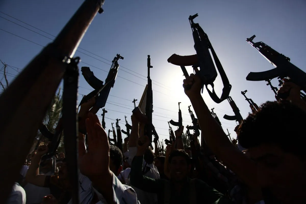 Iraqi Shiite tribesmen brandish their weapons as they gather to show their willingness to join Iraqi security forces in the fight against Jihadist militants who have taken over several northern Iraqi cities, on June 17, 2014, in the southern Shiite Muslim shrine city of Najaf. (Haidar Hamdani/AFP/Getty Images)