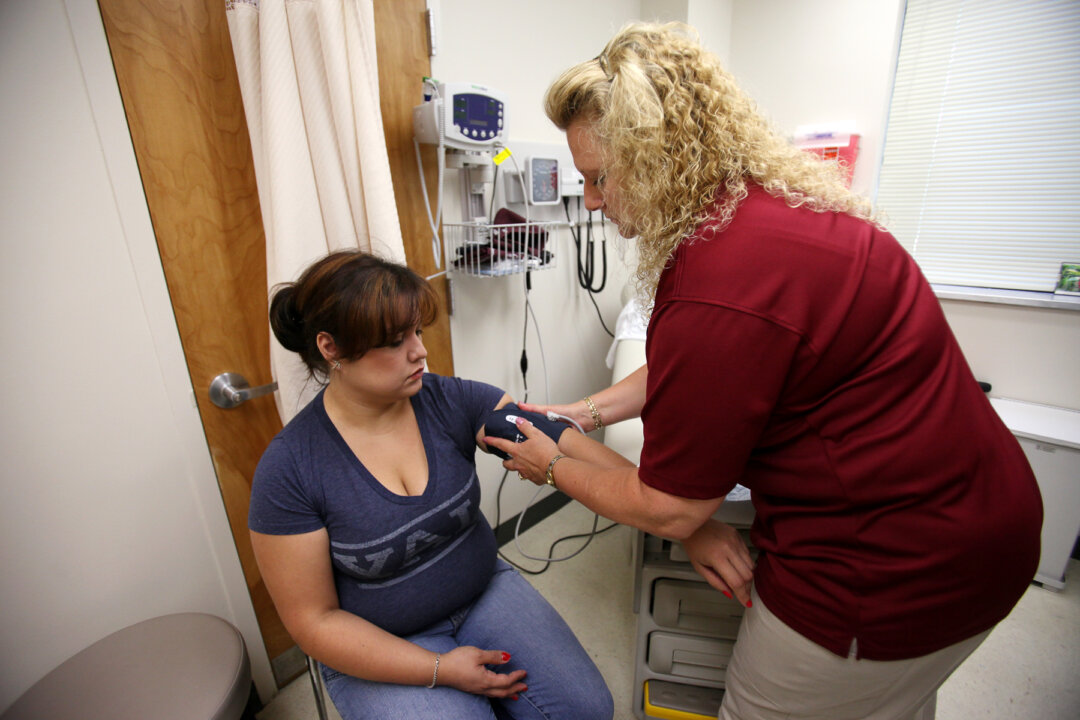Ginger Spruill (L) of Piney Orchard has her blood pressure checked by nurse Jean Sprinks of Odenton, during Kimbrough Ambulatory Care Center's annual Women's Health Fair in Fort Meade on June 2, 2012. Spruill's husband is Staff Sgt. William Spruill. (Jen Rynda/Fort George G. Meade Public Affairs Office/Flickr, CC BY)