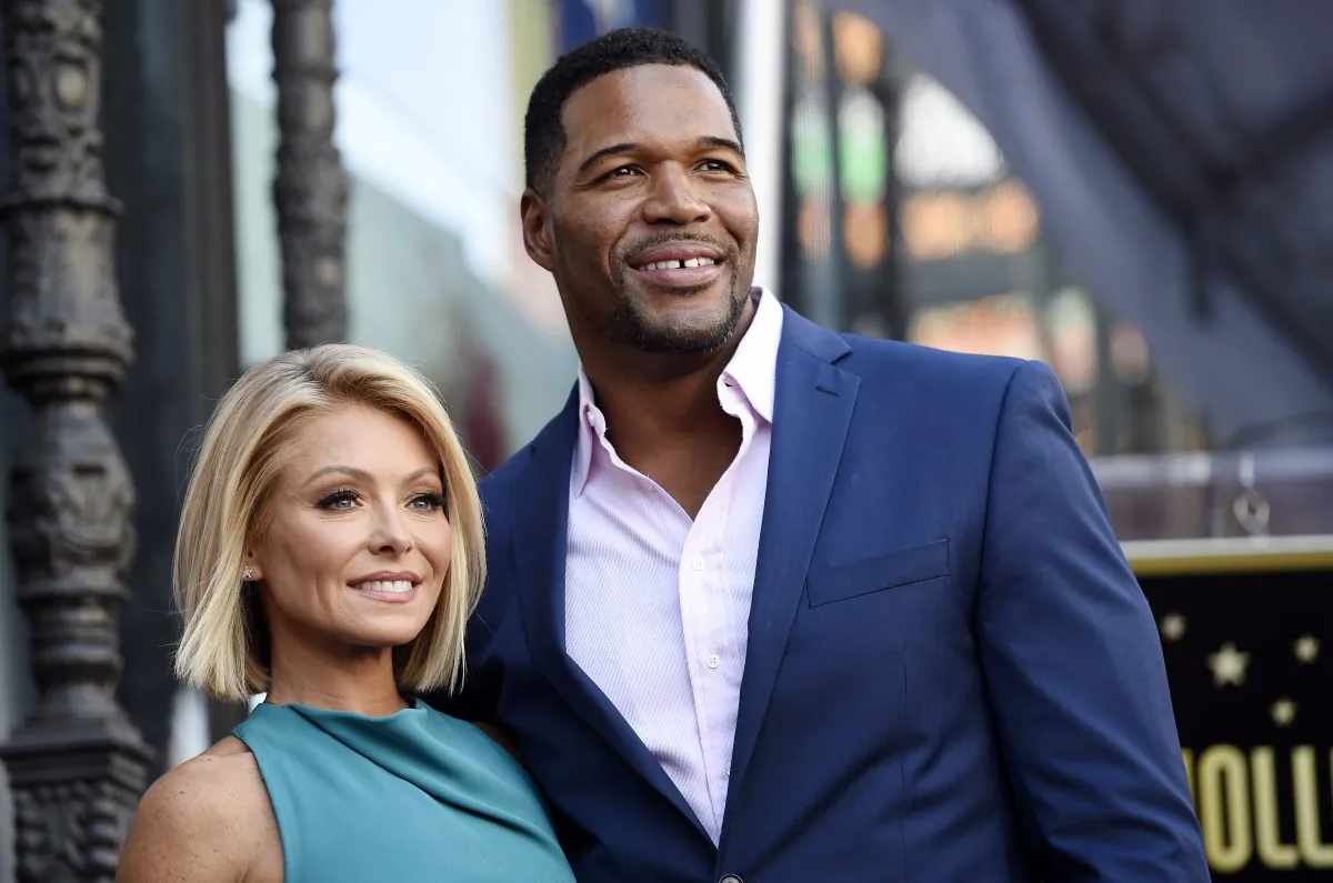 In this Oct. 12, 2015 file photo, Kelly Ripa, left, poses with Michael Strahan, her co-host on the daily television talk show "Live with Kelly and Michael," during a ceremony honoring Ripa with a star on the Hollywood Walk of Fame in Los Angeles. (Photo by Chris Pizzello/Invision/AP, File)