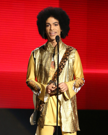 Prince presents the award for favorite album - soul/R&B at the American Music Awards at the Microsoft Theater on Sunday, Nov. 22, 2015, in Los Angeles. (Photo by Matt Sayles/Invision/AP)