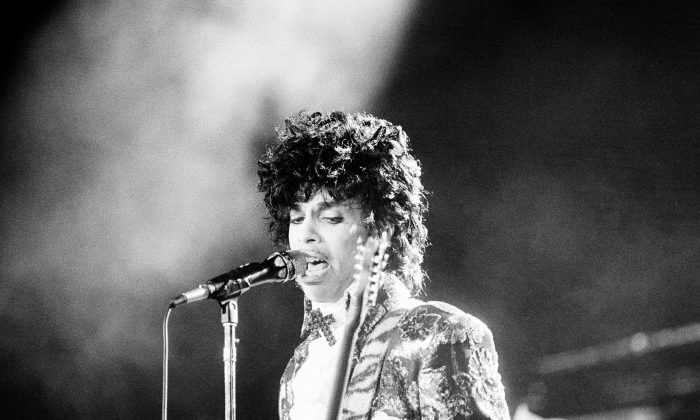 Rock singer Prince performs at the Orange Bowl during his Purple Rain tour in Miami, Fla., April 7, 1985. (AP Photo/Phil Sandlin)