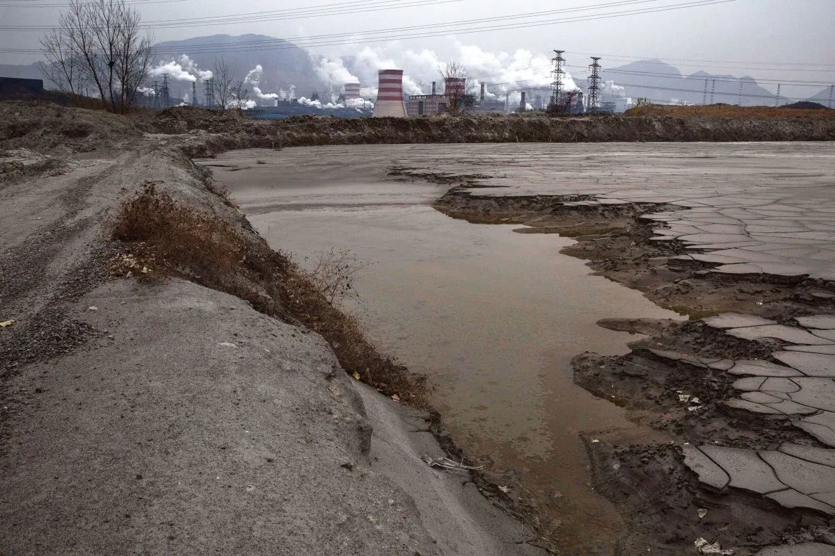Heavily polluted water is seen in a pool outside a steel factory on Nov 19, 2015. (Kevin Frayer/Getty Images)