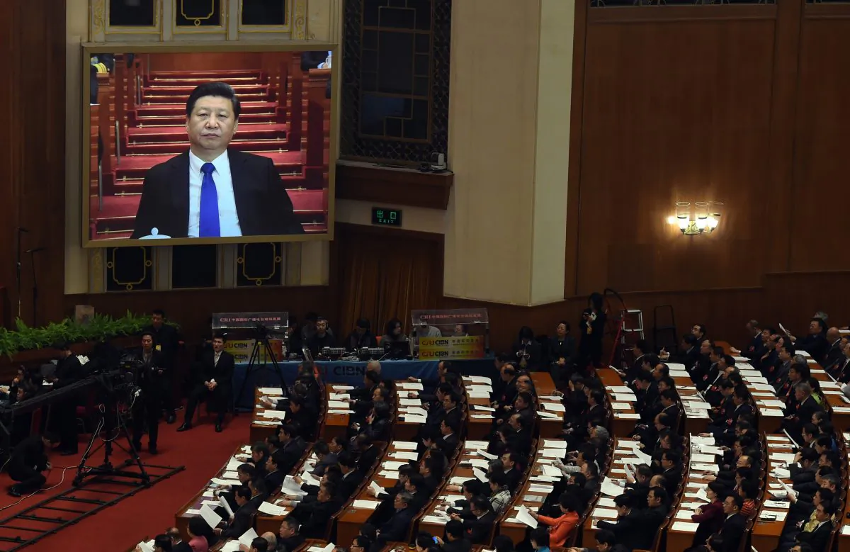 Chinese leader Xi Jinping is on a screen as he prepares for a speach at the Great Hall of the People in Beijing on March 3, 2016. (Greg Baker/AFP/Getty Images)