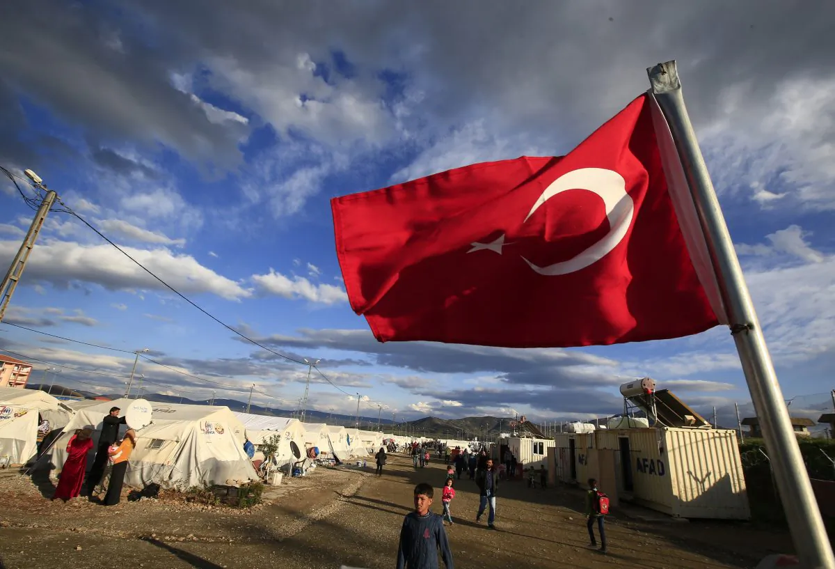 A Turkish flag flies at the refugee camp for Syrian refugees in Islahiye, Gaziantep Province, southeastern Turkey, on March 16, 2016. (AP Photo/Lefteris Pitarakis)