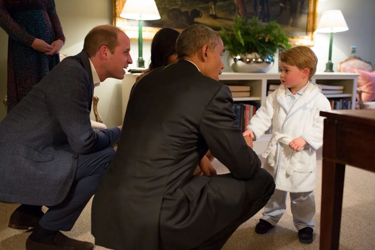 In this hand out photo released by Kensington Palace, Britain's Prince George meets with US  President Barack Obama, centre and first lady Michelle Obama , at Kensington Palace, London, Friday April 22, 2016. Prince William is at left. (Pete Souza/Kensington Palace via AP)