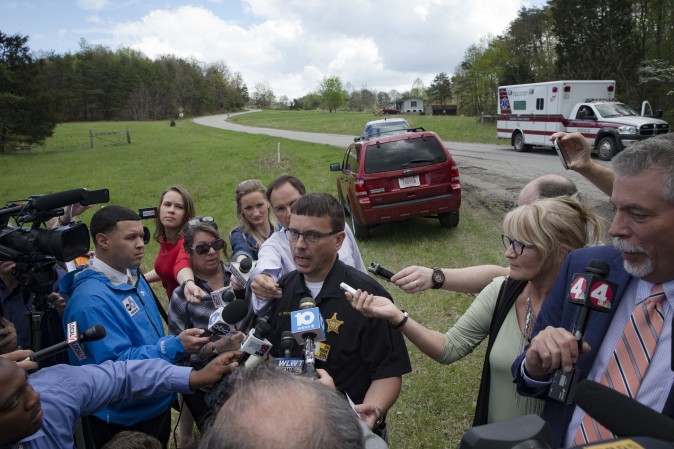 Lt. Michael Preston, of the Ross County Sheriff's Department speaks to the media on Union Hill Road that approaches a crime scene, in Pike County, Ohio, on April 22, 2016. (AP Photo/John Minchillo)