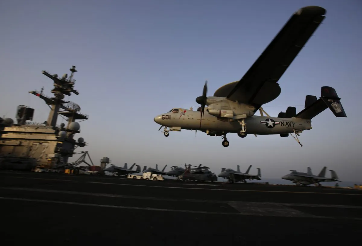 An aircraft lands after missions targeting the Islamic State in Iraq from the deck of the U.S. Navy aircraft carrier USS George H.W. Bush in the Persian Gulf on Aug. 10, 2014. (AP Photo/Hasan Jamali)