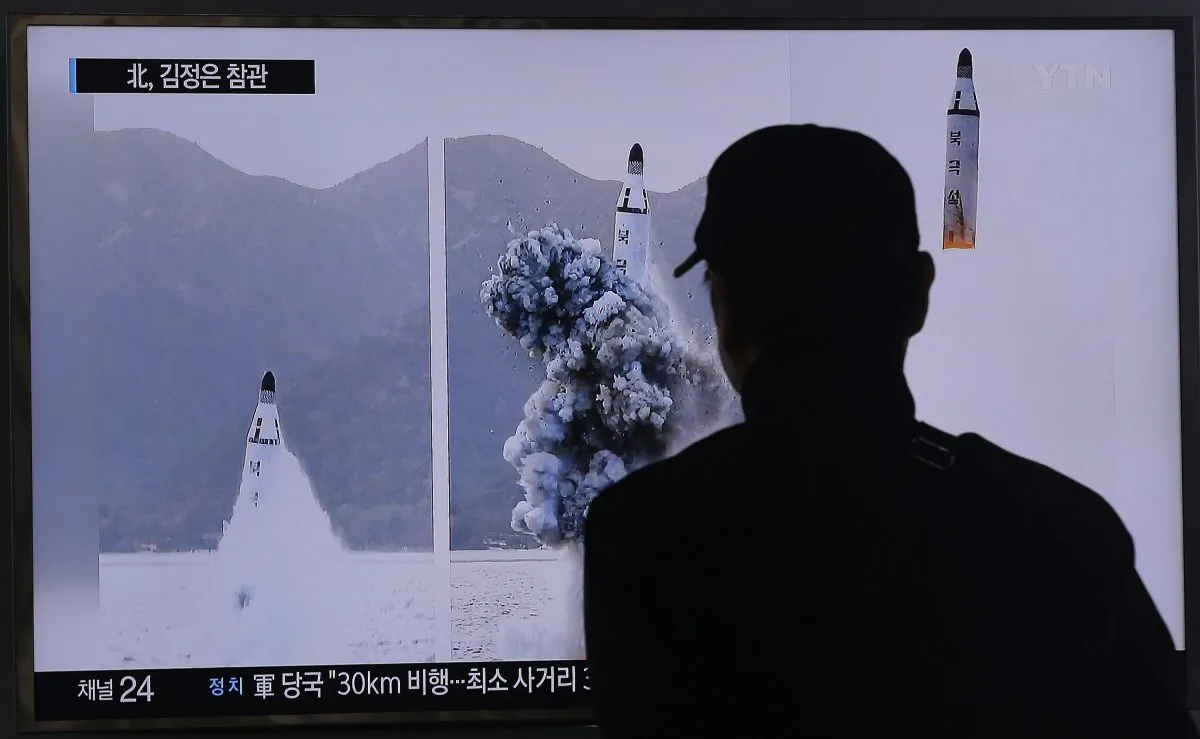 A South Korean man watches a TV news program showing images published Sunday in North Korea's Rodong Sinmun newspaper of North Korea's ballistic missile that the North claimed to have launched from underwater, at Seoul Railway station in Seoul, South Korea, on April 24, 2016. (AP Photo/Ahn Young-joon)