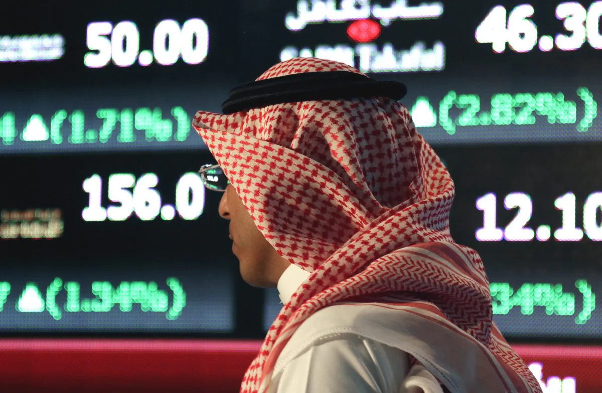 A Saudi man at the Tadawul Saudi Stock Exchange, in Riyadh, Saudi Arabia, on June 15, 2015. The Saudi economy is becoming undone by a low oil price and a strong dollar. (AP Photo/Hasan Jamali)
