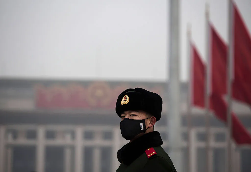 A Chinese Paramilitary police officer wears a mask to protect against pollution in Tiananmen Square in Beijing on Dec. 9, 2015. (Kevin Frayer/Getty Images)