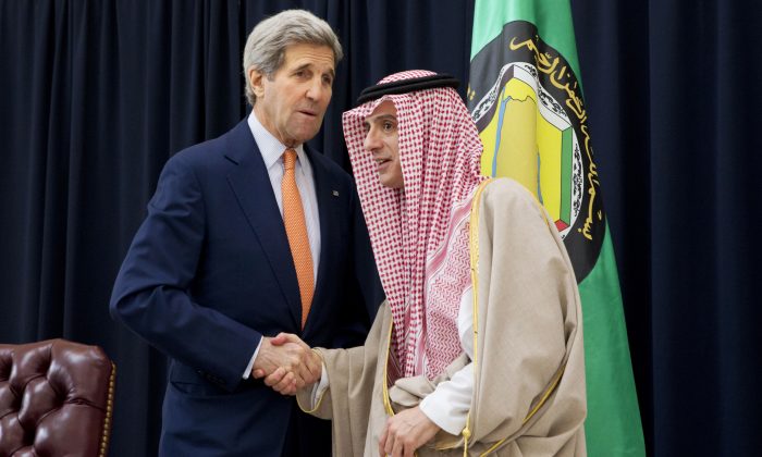Saudi Foreign Minister Adel al-Jubeir (R) shakes hands with US Secretary of State John Kerry during a joint press conference after a meeting with foreign ministers from the six-nation Gulf Cooperation Council at King Salman airbase on January 23, 2016 in Riyadh.   
(JACQUELYN MARTIN/AFP/Getty Images)