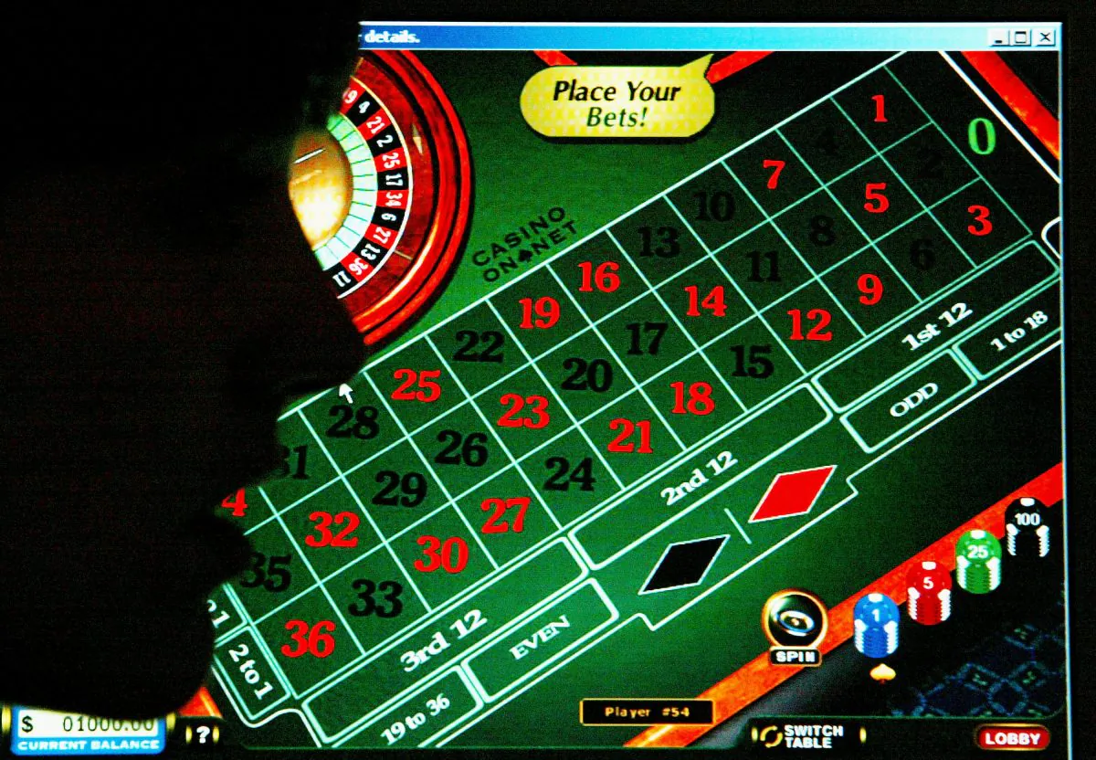 A woman looks at a casino website in London on July 27, 2004. Internet gambling websites should introduce age-verification checks to prevent children from betting online, the children's charity NCH urged. The call by NCH came after it found that a 16-year-old girl was able to register with 30 gambling sites after lying about her age. (Graeme Robertson/Getty Images)