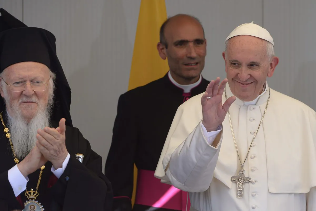 Pope Francis (R) and Ecumenical Patriarch Bartholomew I, spiritual leader of the worlds Orthodox Christians visit the Moria refugee camp on April 16, 2016 near the port of Mytilene, in the Greek island of Lesbos. Pope Francis received an emotional welcome today on the Greek island of Lesbos during a visit aimed at showing solidarity with migrants fleeing war and poverty.  Pope Francis, Orthodox Patriarch Bartholomew and Archbishop Jerome visit Lesbos today to turn the spotlight on Europe's controversial deal with Turkey to end an unprecedented refugee crisis.  AFP PHOTO POOL / FILIPPO MONTEFORTE / AFP / POOL / FILIPPO MONTEFORTE        (Photo credit should read FILIPPO MONTEFORTE/AFP/Getty Images)
