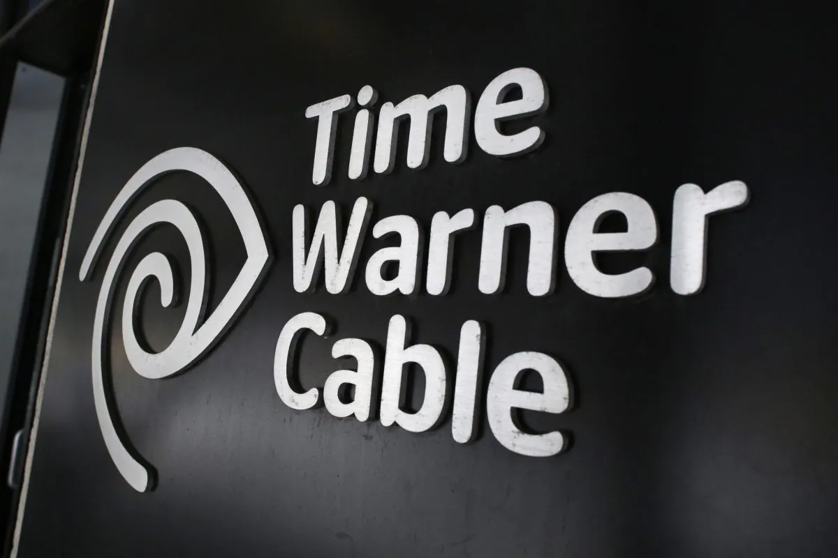 In this May 26, 2015, file photo, the Time Warner Cable corporate logo is displayed at a company store, in New York. (AP Photo/Mark Lennihan)