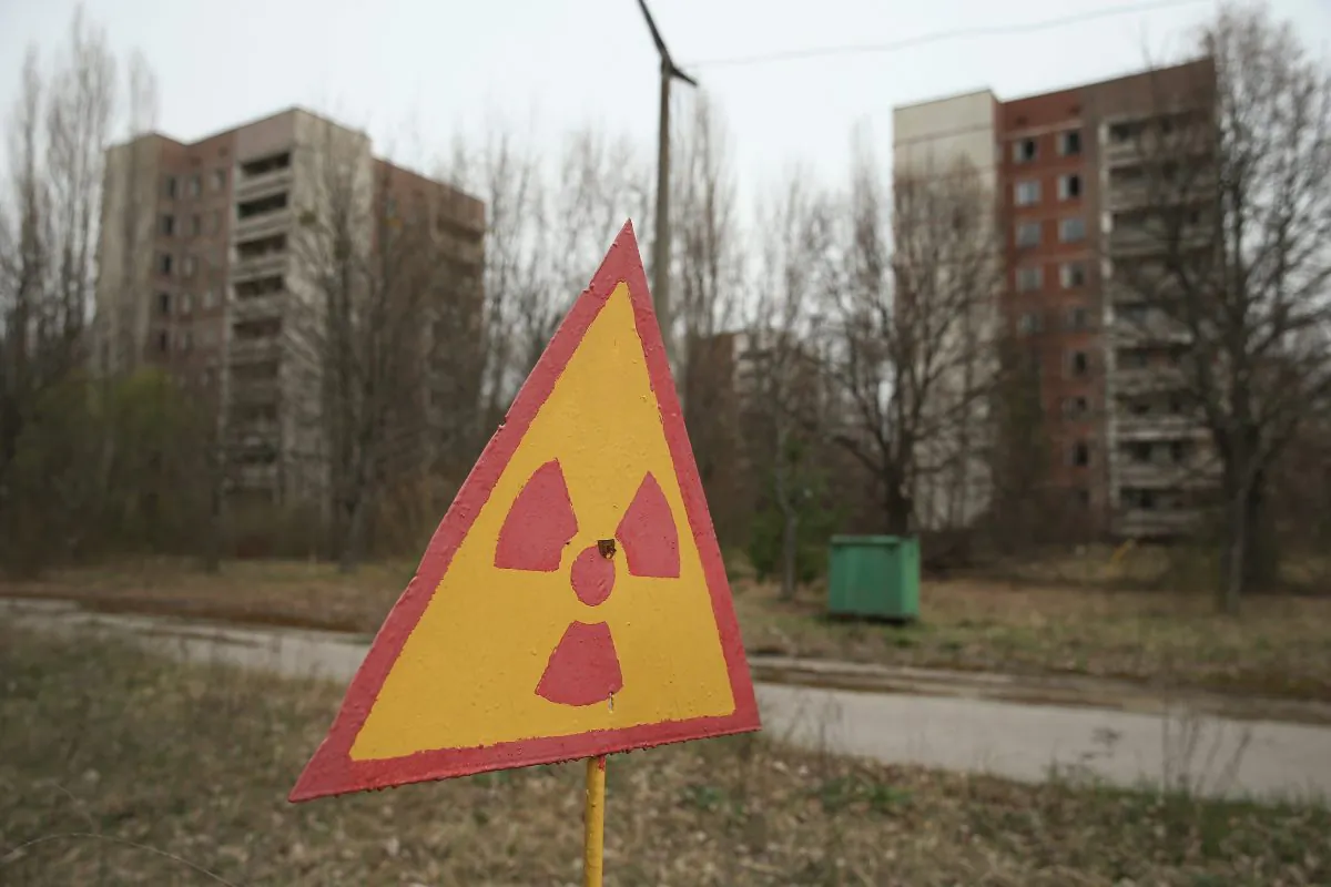 A sign warns of radiation contamination near former apartment buildings in Pripyat, near Chernobyl, Ukraine, on April 9, 2016.  (Sean Gallup/Getty Images)