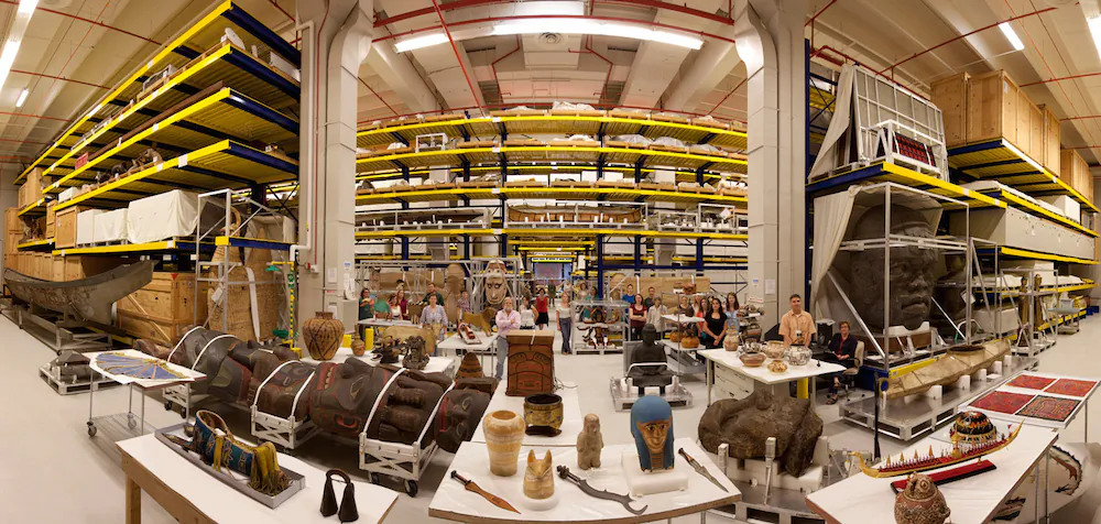 Anthropological collections on display in Pod 4 (designed to house oversized objects) at the Smithsonian Institution's Museum Support Center (MSC), located in Suitland, Maryland. Anthropology collections staff present. Panoramic image #7 of 7 at 26mm focal length.