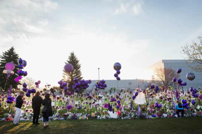 Music fans visit a memorial created outside Paisley Park, the home and studio of Prince, on April 23, 2016 in Chanhassen, Minnesota. Prince, 57, was pronounced dead shortly after being found unresponsive in an elevator April 21 at Paisley Park. (Scott Olson/Getty Images)